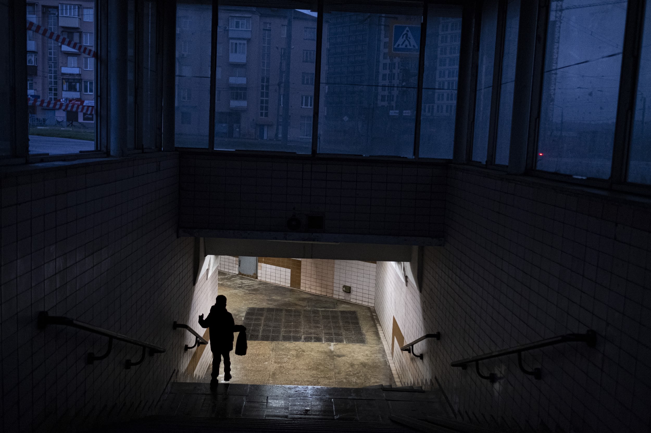 A child walks down the stairs from the street into a metro station in Kharkiv.